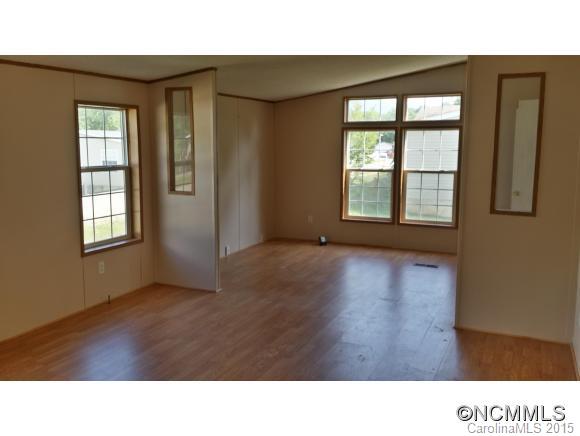 91 Austin Road Clyde, NC 28721 - Photo 16 of 23 a open hall with a window and wooden floor
