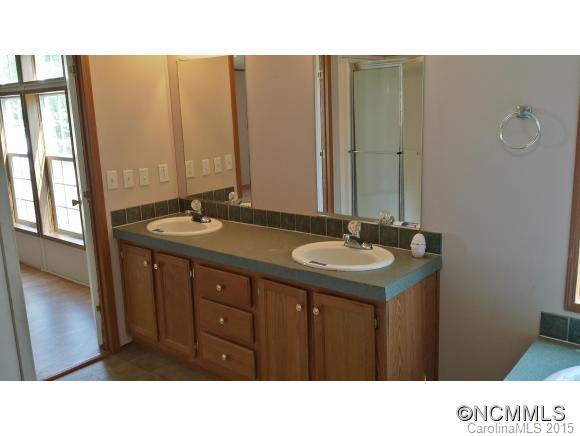 91 Austin Road Clyde, NC 28721 - Photo 19 of 23 a bathroom with a sink vanity and a mirror