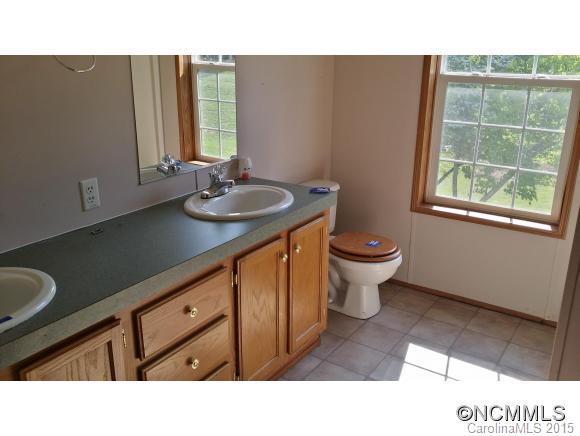 91 Austin Road Clyde, NC 28721 - Photo 21 of 23 a bathroom with a sink a toilet and a window