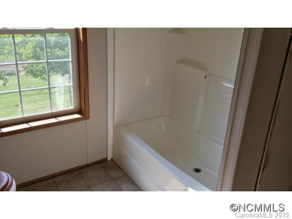91 Austin Road Clyde, NC 28721 - Photo 22 of 23 a bathroom with a sink and a bathtub