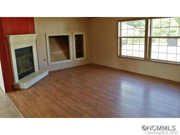 91 Austin Road Clyde, NC 28721 - Photo 9 of 23 a open living room with a large window