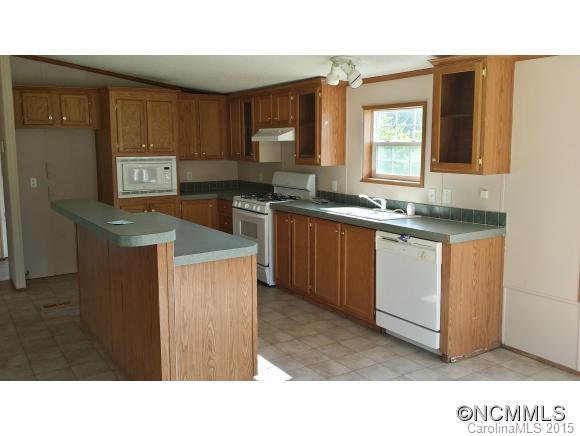 91 Austin Road Clyde, NC 28721 - Photo 10 of 23 a kitchen with stainless steel appliances granite countertop a sink stove and cabinets