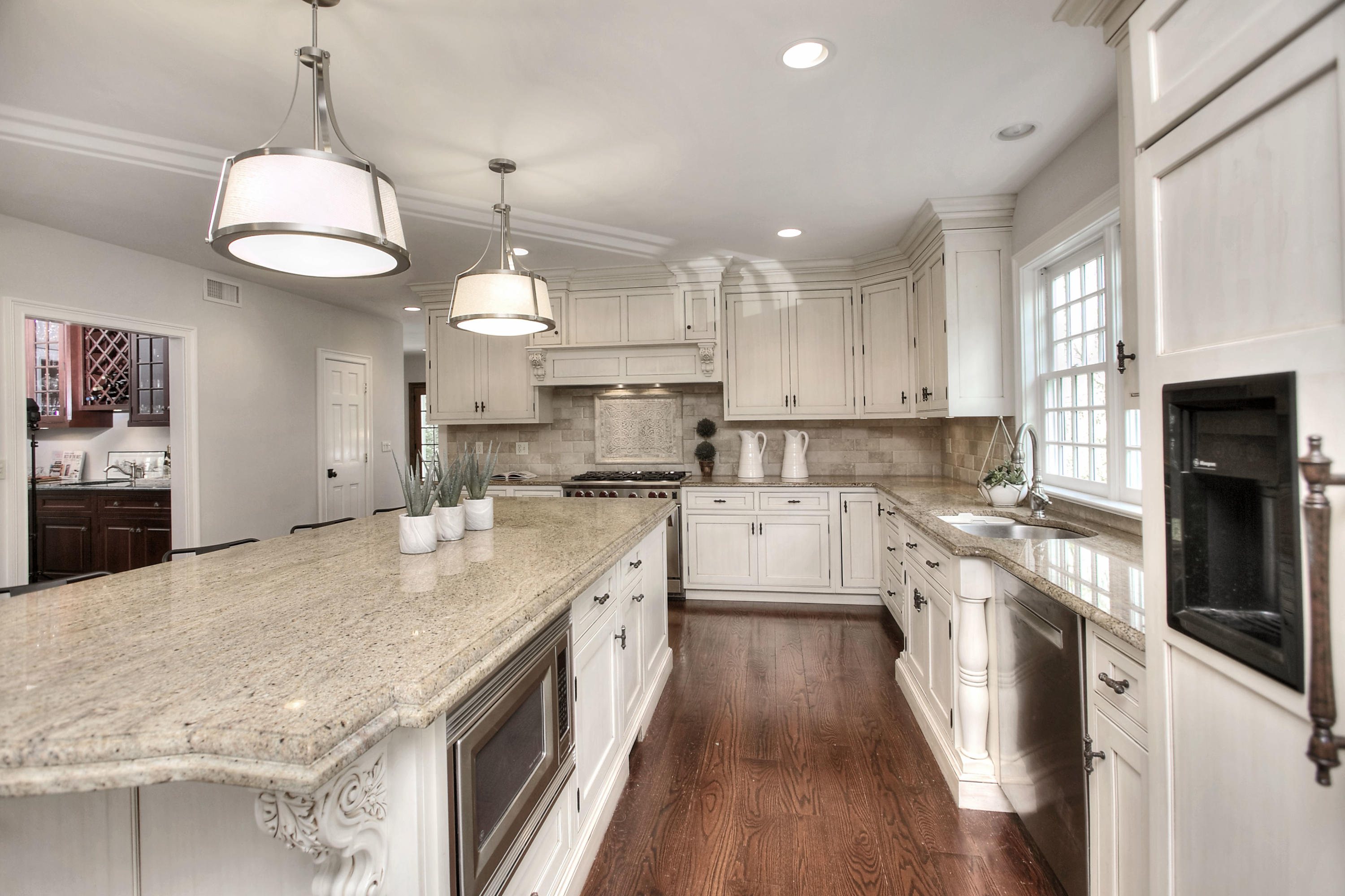 25 Point O Woods Road Darien, CT 06820 - Photo 26 of 68 a kitchen with kitchen island granite countertop a sink a counter space appliances and cabinets