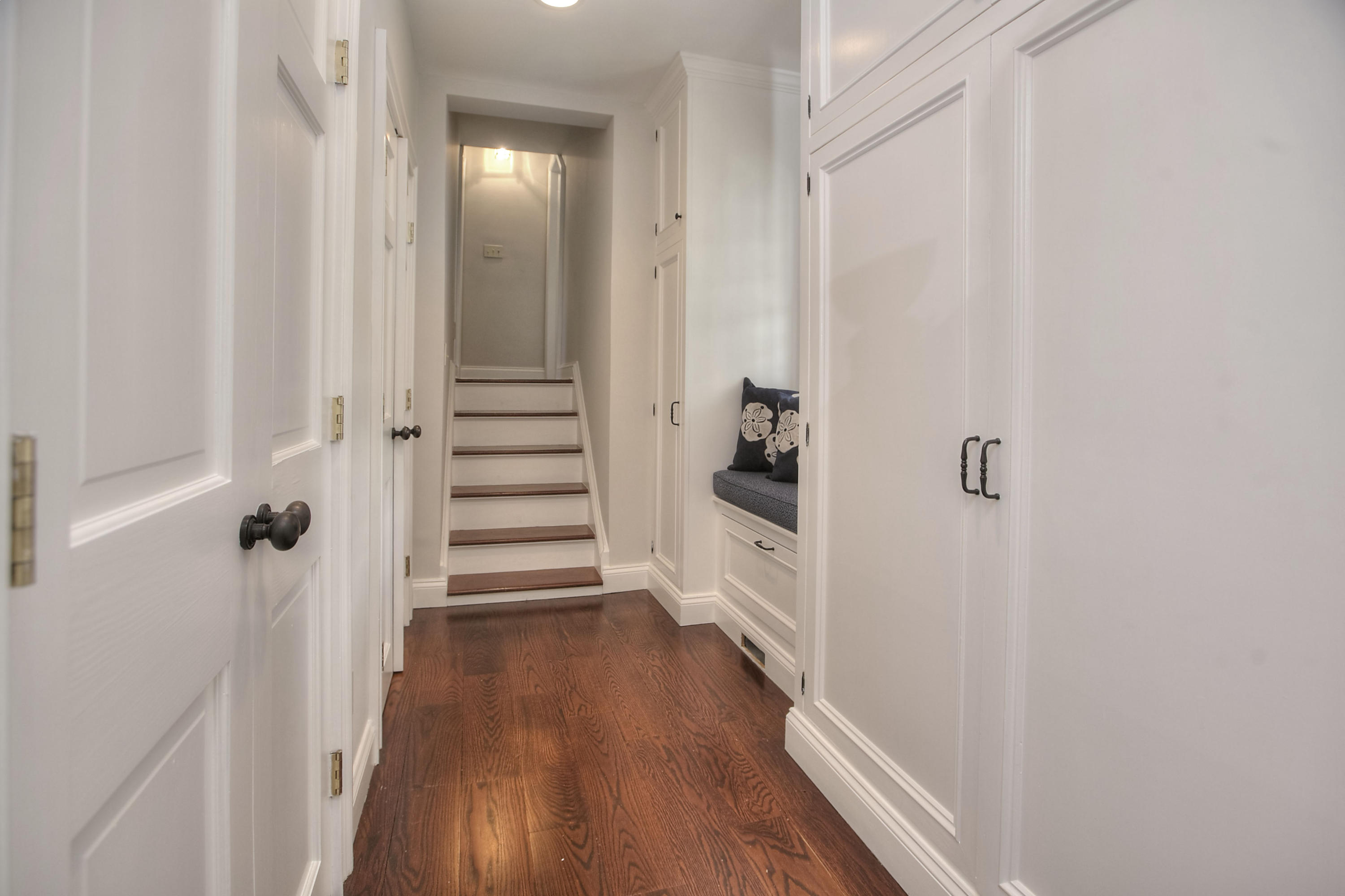 25 Point O Woods Road Darien, CT 06820 - Photo 30 of 68 a view of a hallway with wooden floor and staircase