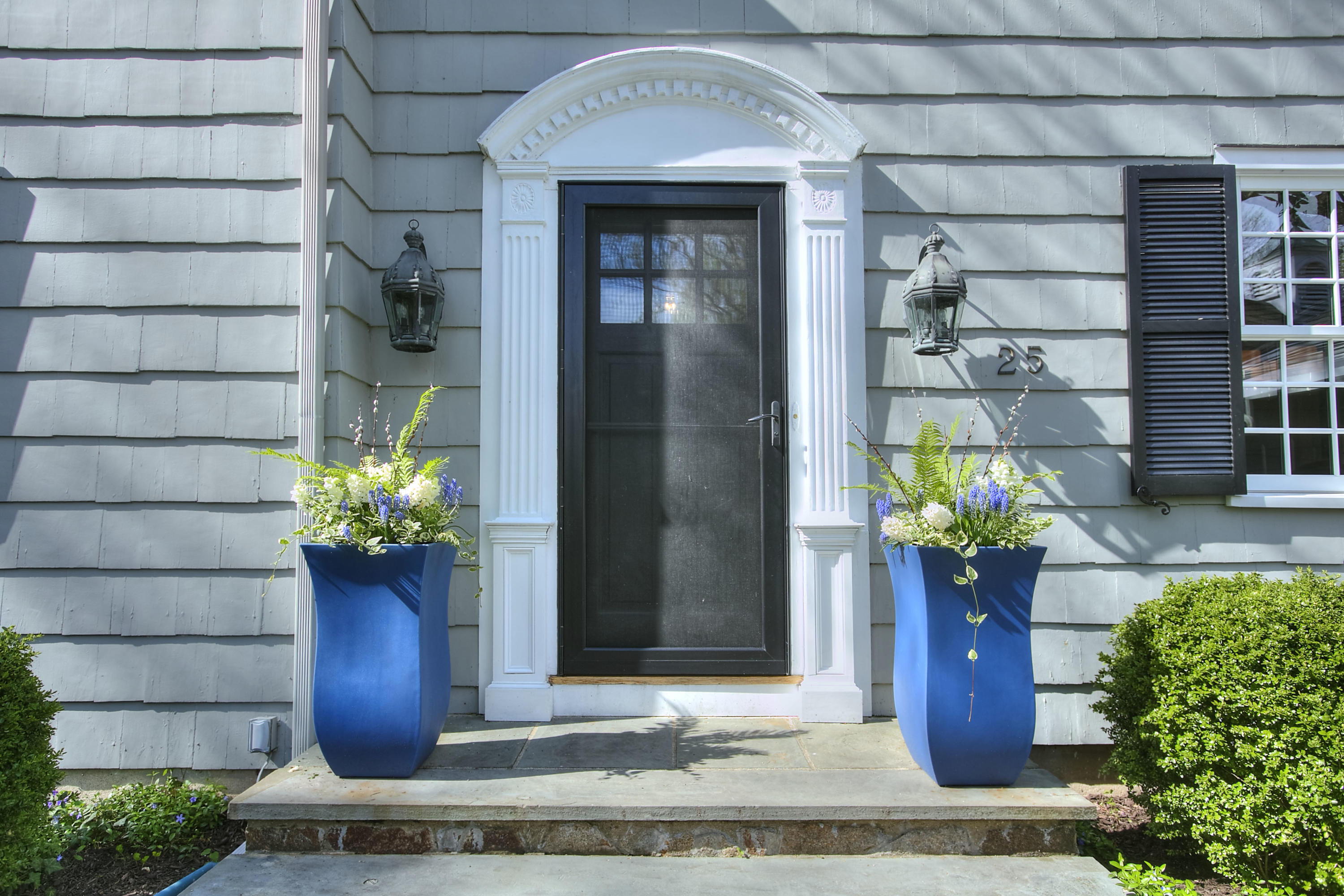 25 Point O Woods Road Darien, CT 06820 - Photo 3 of 68 a front view of a house with a garden