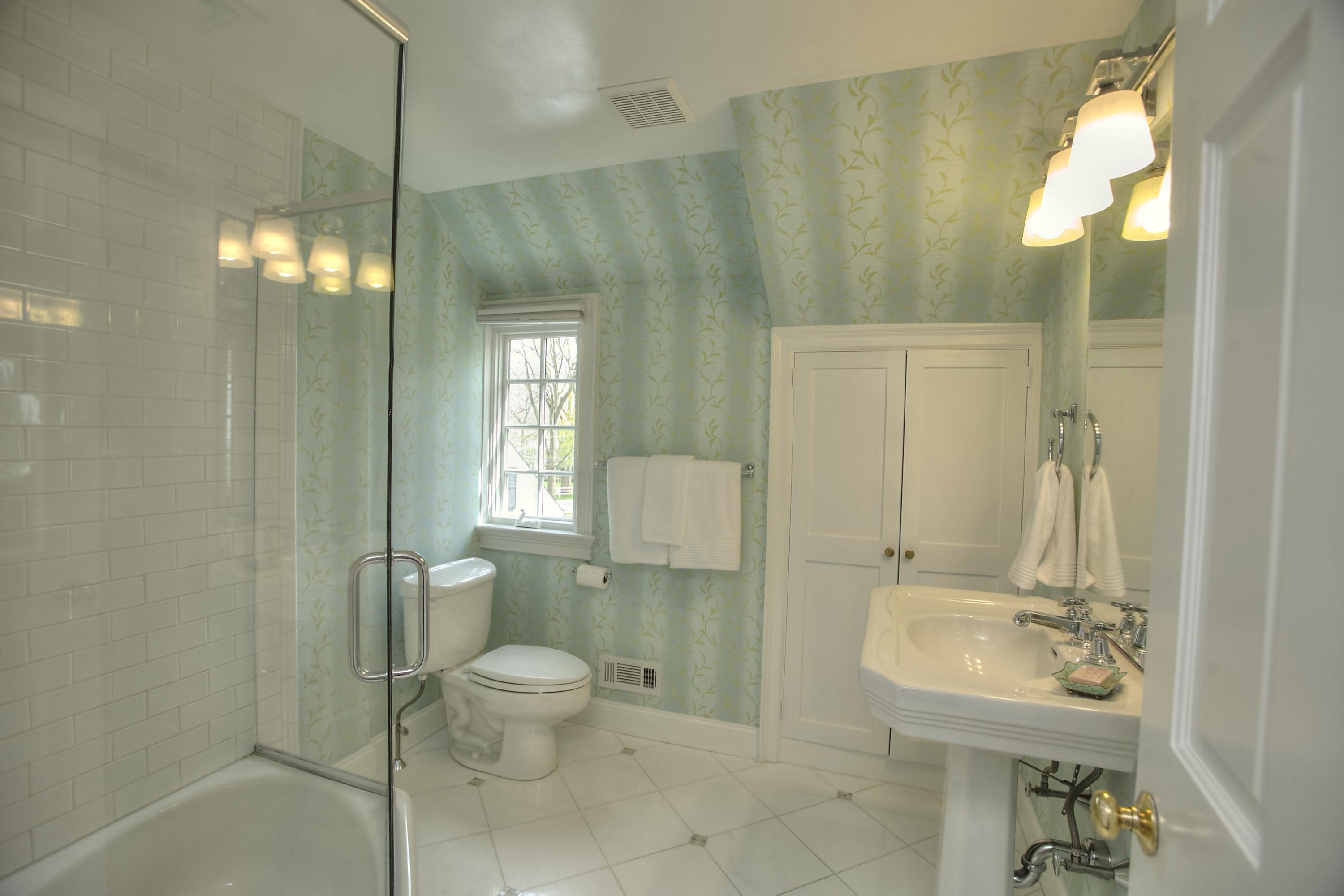 25 Point O Woods Road Darien, CT 06820 - Photo 37 of 68 a bathroom with a toilet sink and mirror