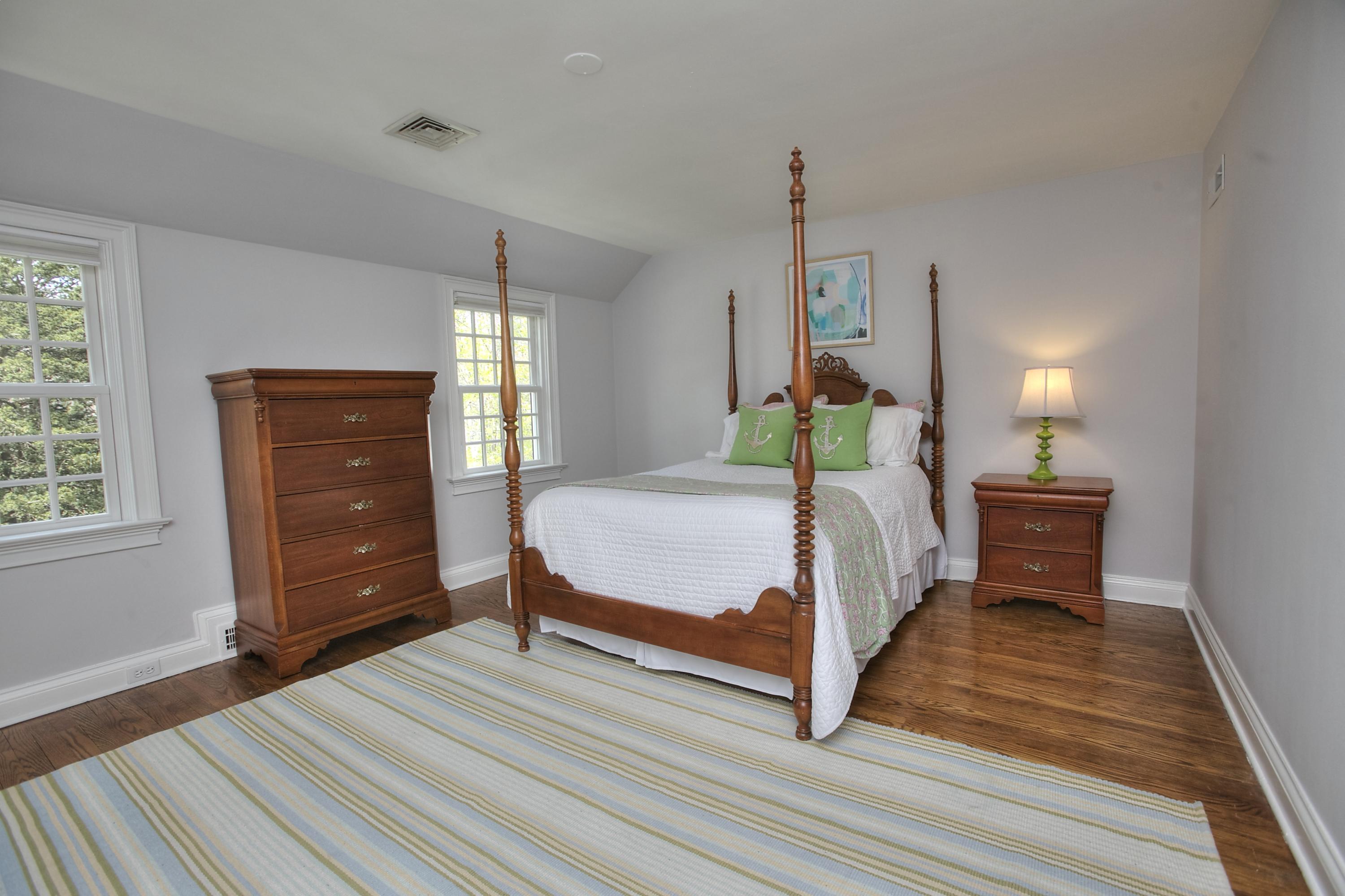 25 Point O Woods Road Darien, CT 06820 - Photo 38 of 68 a bedroom with a bed a dresser and window