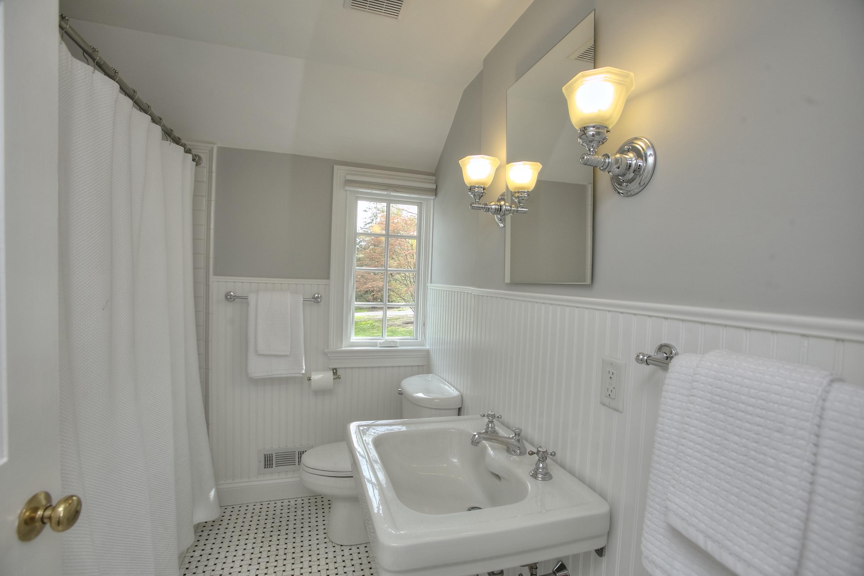 25 Point O Woods Road Darien, CT 06820 - Photo 39 of 68 a bathroom with a sink a toilet and a mirror
