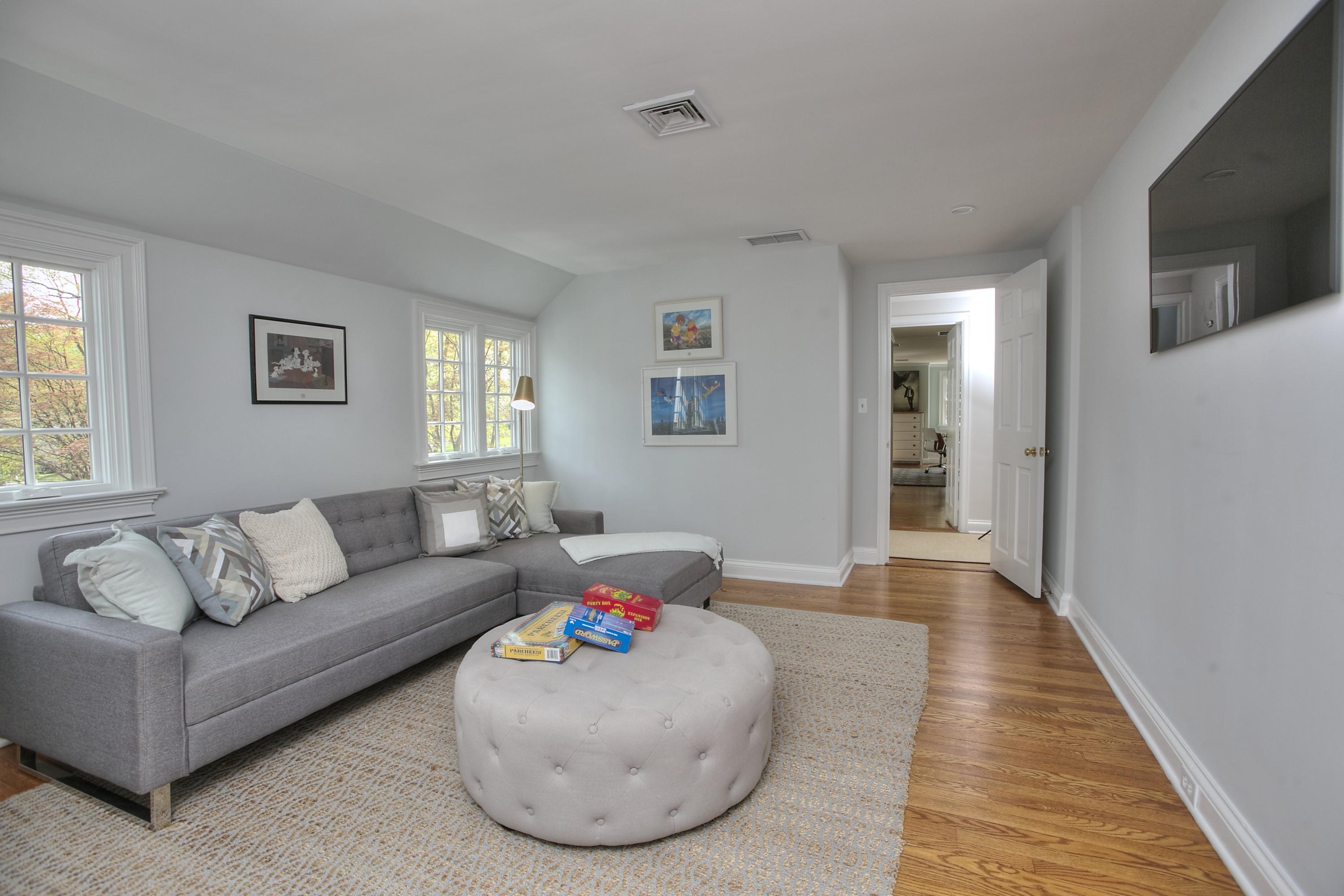25 Point O Woods Road Darien, CT 06820 - Photo 40 of 68 a living room with furniture and a flat screen tv