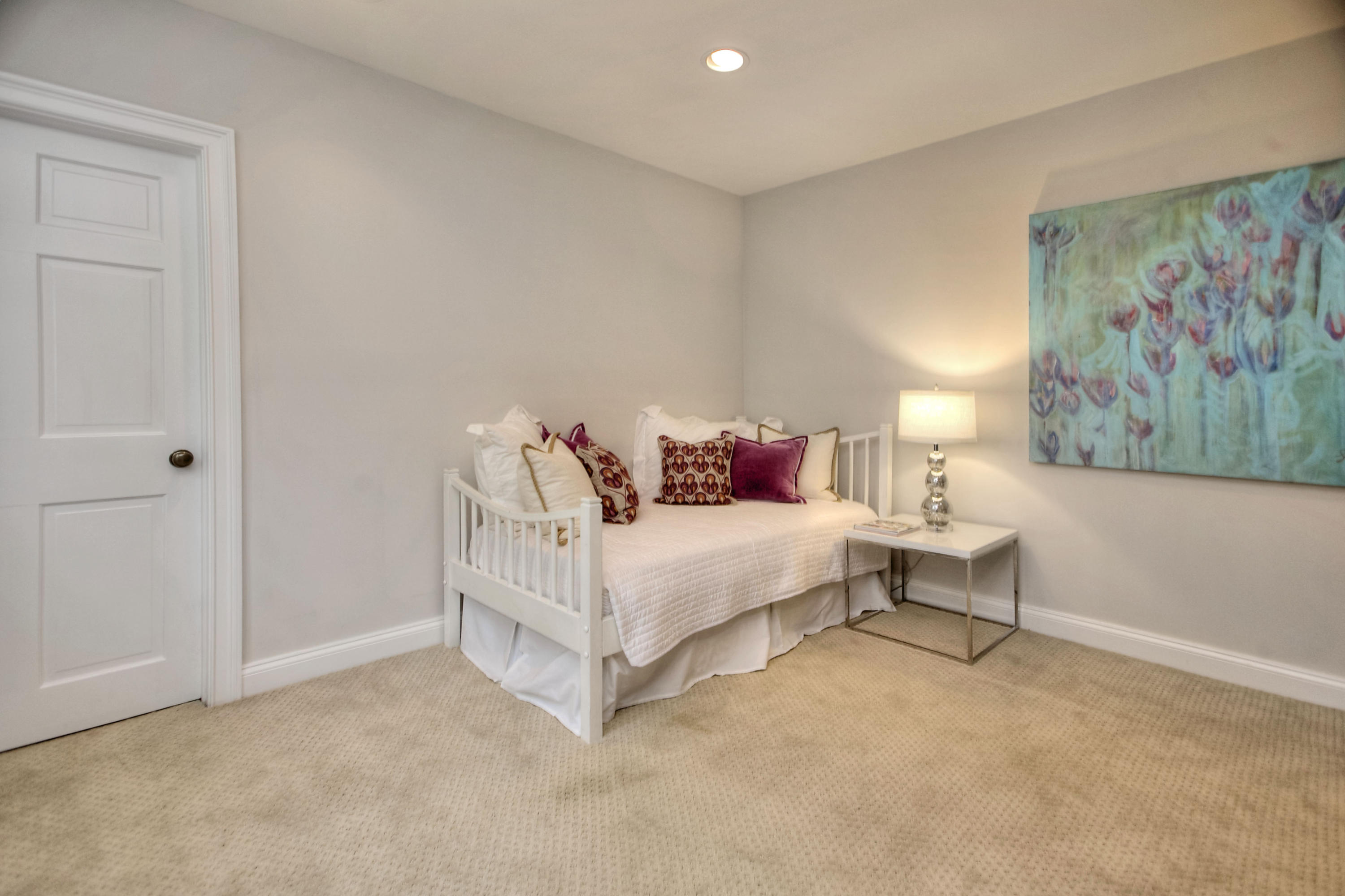 25 Point O Woods Road Darien, CT 06820 - Photo 54 of 68 a white bed sitting in a bedroom next to a small bathroom