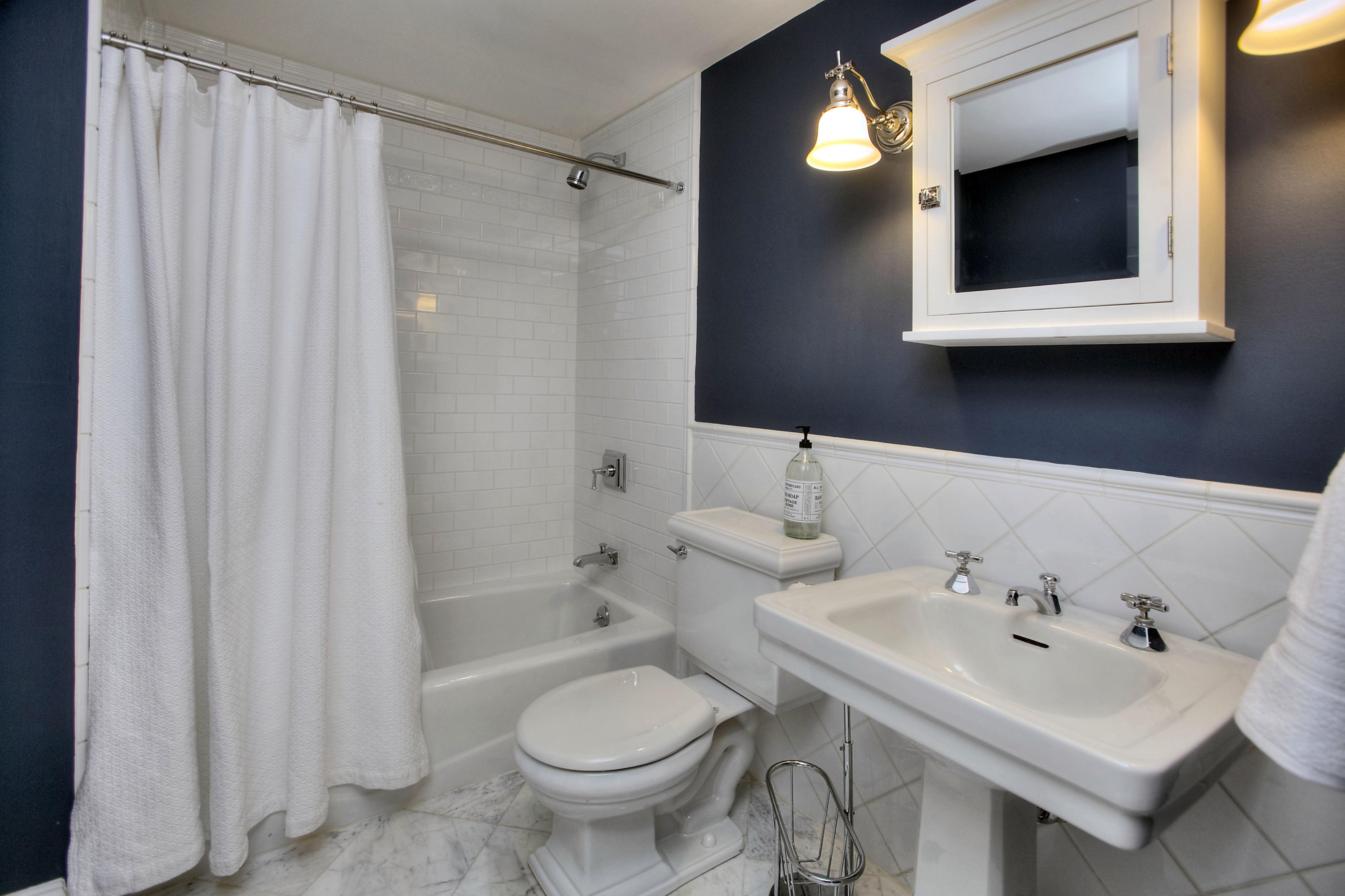 25 Point O Woods Road Darien, CT 06820 - Photo 56 of 68 a bathroom with a sink and a mirror