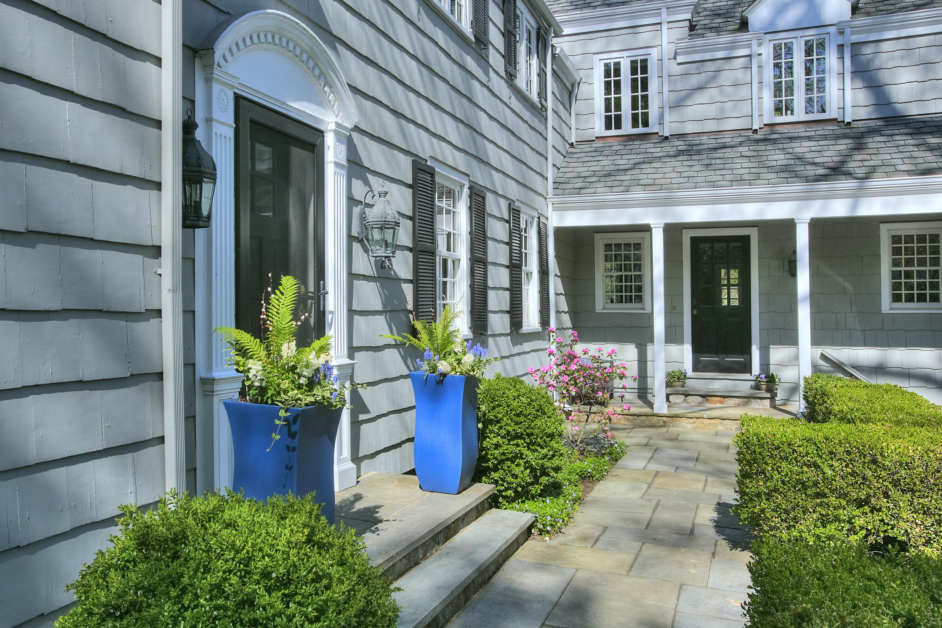 25 Point O Woods Road Darien, CT 06820 - Photo 62 of 68 a front view of a house with a garden