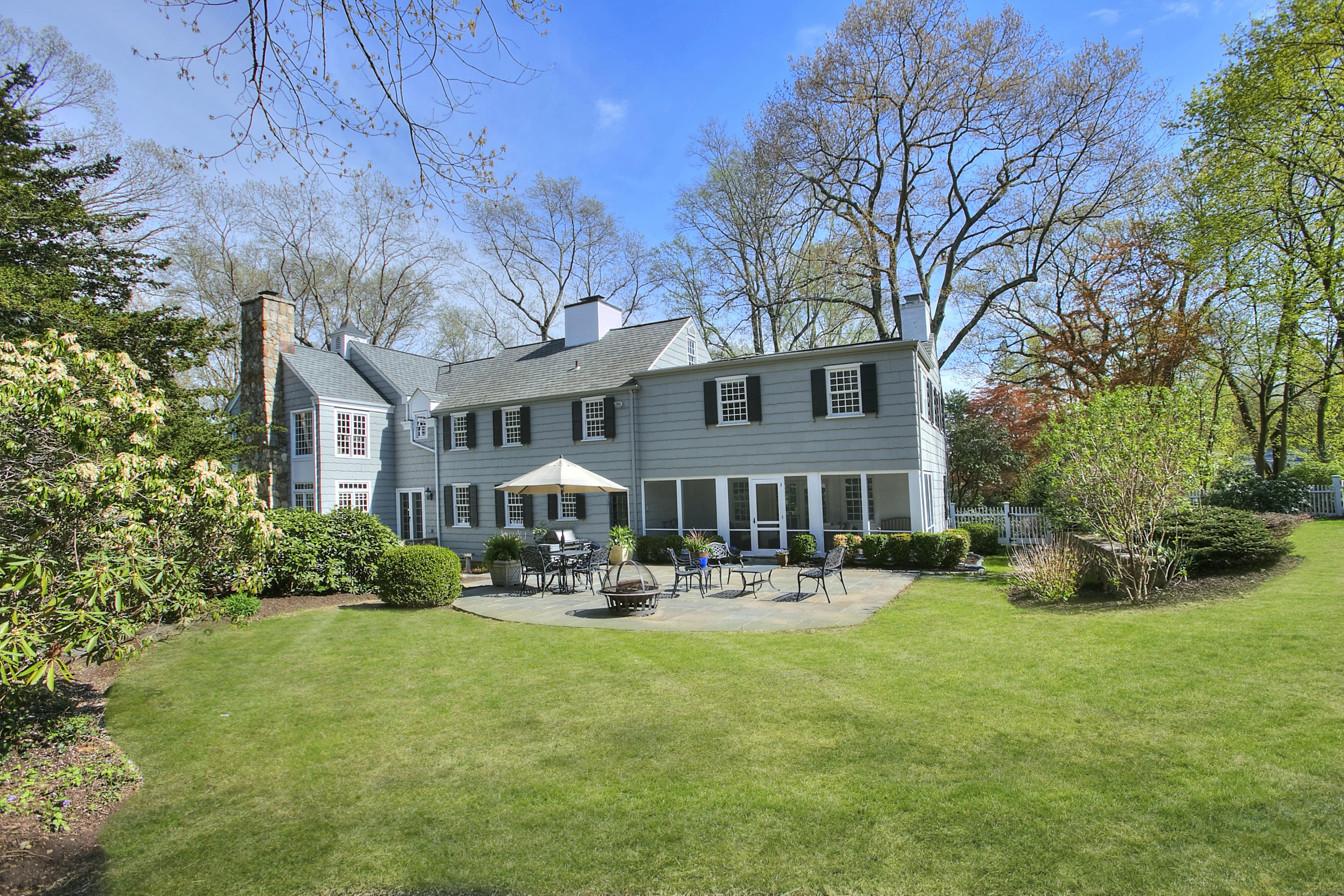 25 Point O Woods Road Darien, CT 06820 - Photo 66 of 68 a front view of a building with garden and trees