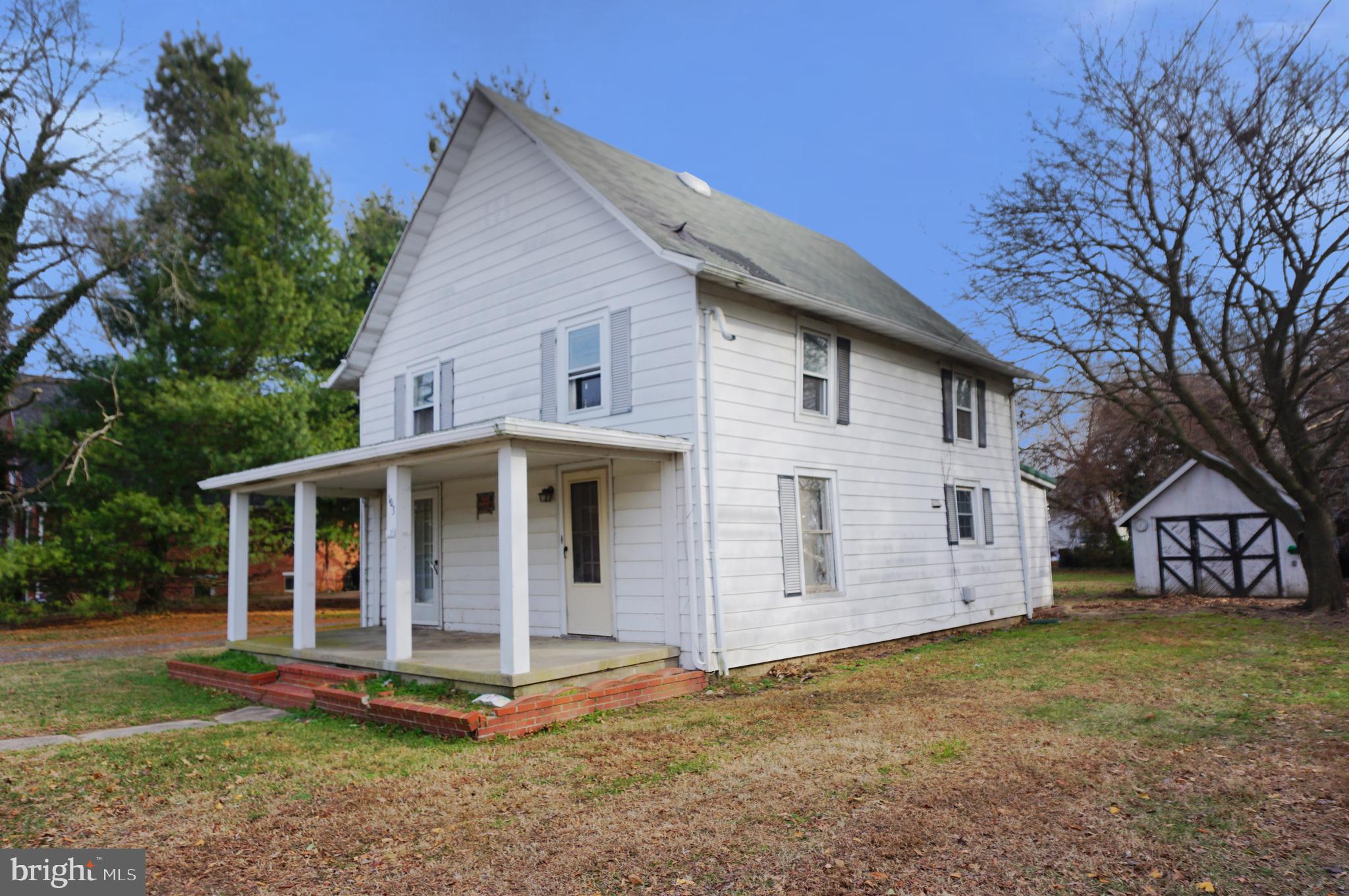 103 Chambers Street Preston, MD 21655 - Photo 3 of 12 a view of a white house with a big yard and large trees