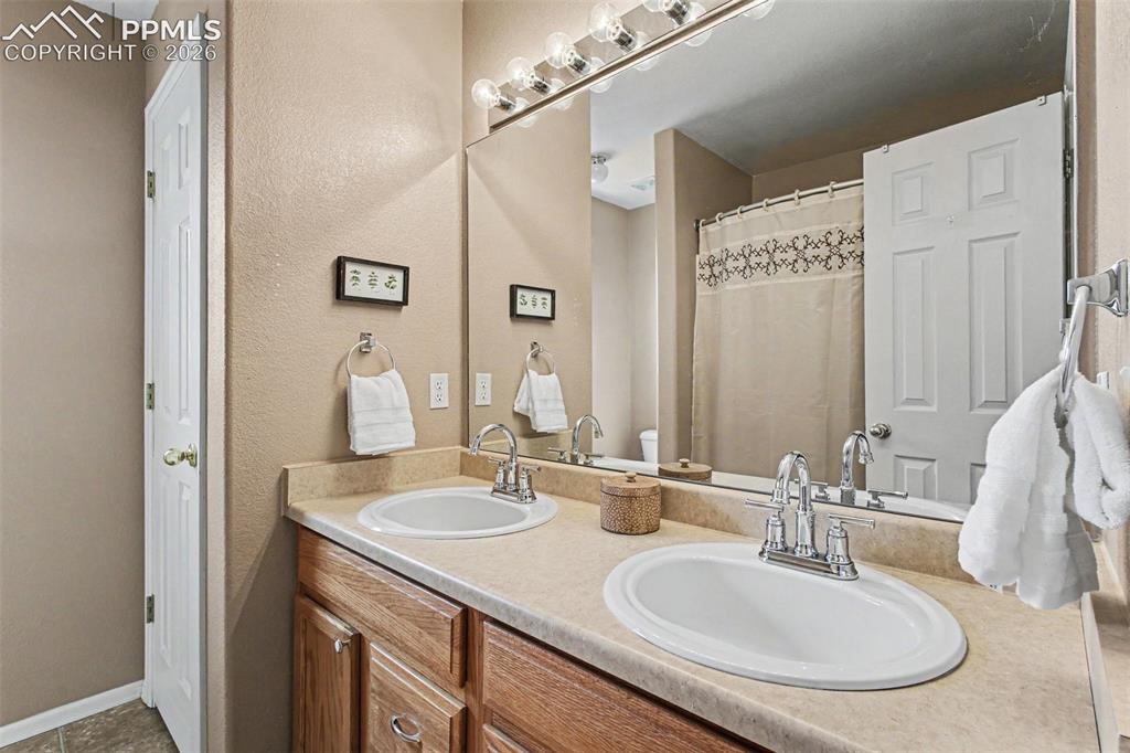 12210 Crystal Downs Road Peyton, CO 80831 - Photo 24 of 40 a bathroom with a sink and a mirror