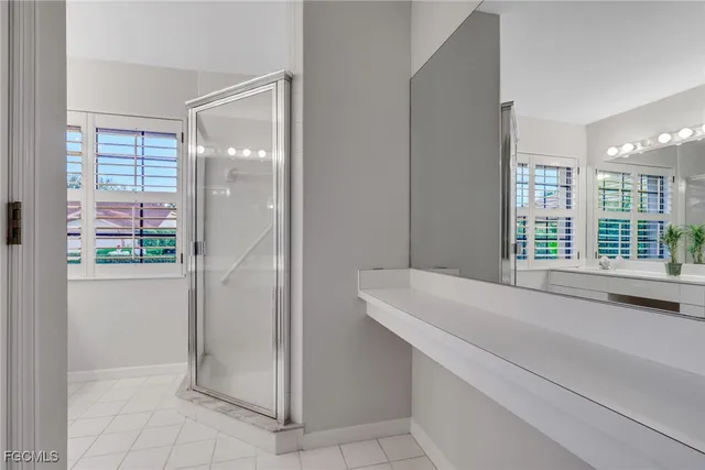 a room with a sink and chandelier