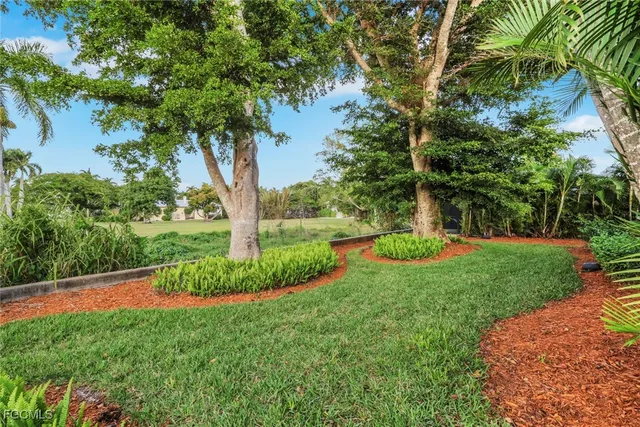 a front view of a house with a yard and outdoor seating