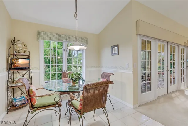 a dining room with furniture and natural light