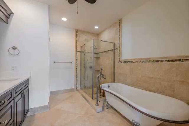 a bathroom with a granite countertop sink mirror vanity and toilet