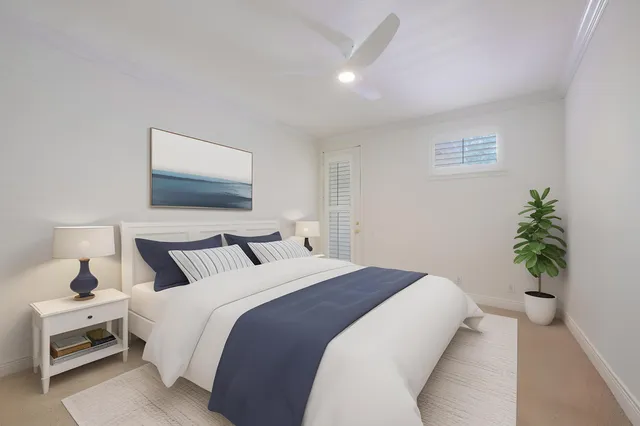 a bedroom with a bed and a potted plant
