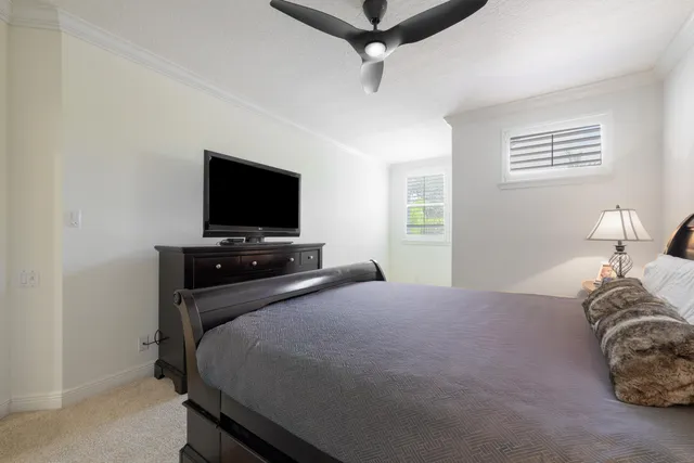 a bedroom with a bed and a tv