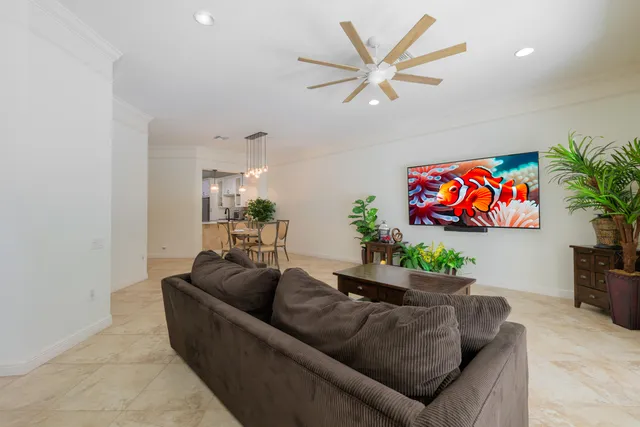 a living room with furniture kitchen and a potted plant