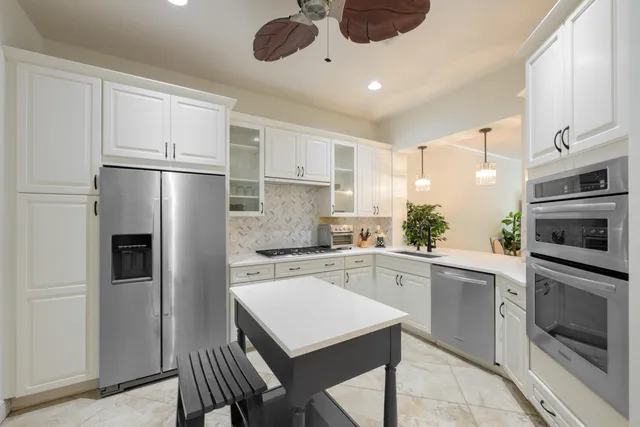 a kitchen with a sink stainless steel appliances and cabinets