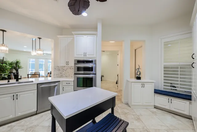 a kitchen with a sink refrigerator and cabinets