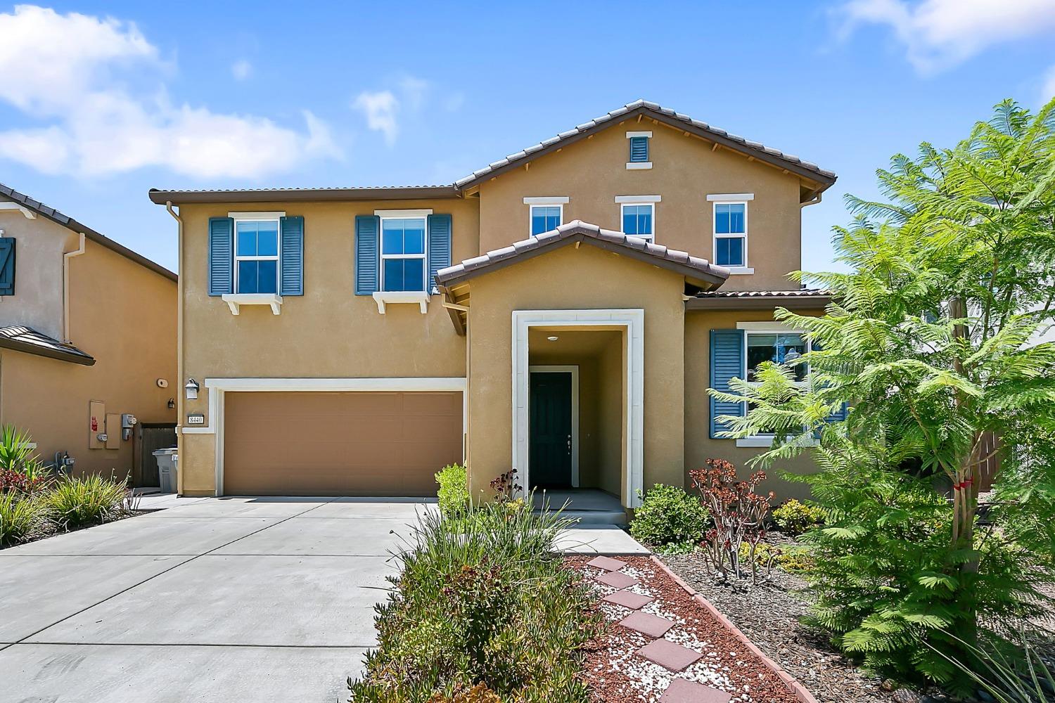 8440 Tolson Street Elk Grove, CA 95758 - Photo 1 of 1 a front view of a house with a garden