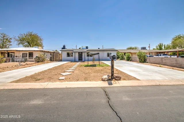 a view of a patio with a table and chairs
