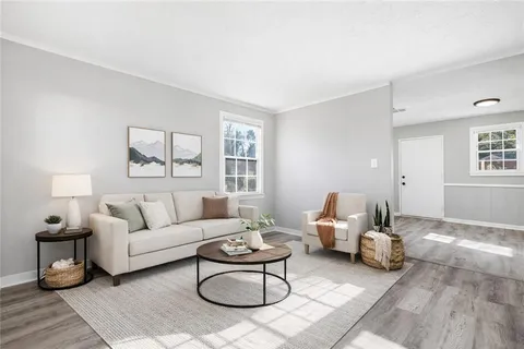 a living room with furniture and wooden floor