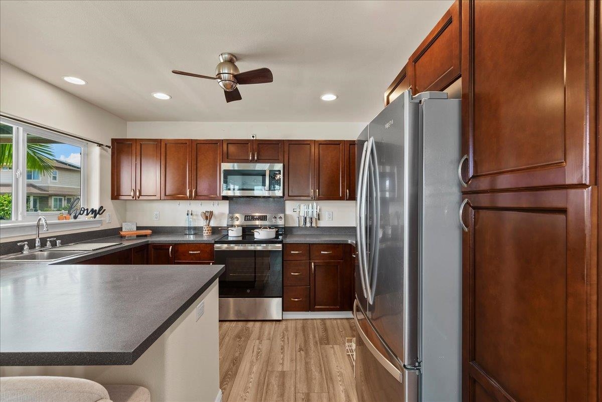 214 Alake Street Kahului, HI 96732 - Photo 14 of 27 a kitchen with stainless steel appliances granite countertop a refrigerator a sink a stove and cabinets