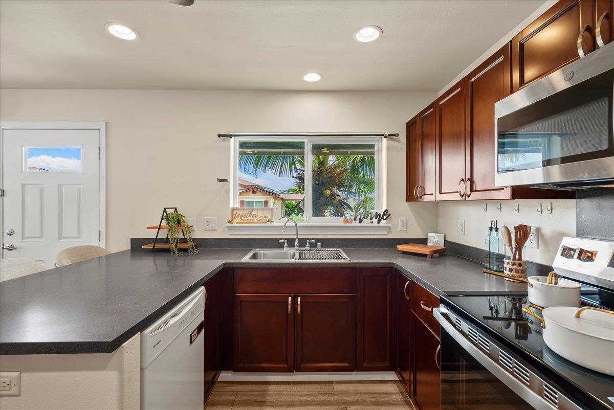 214 Alake Street Kahului, HI 96732 - Photo 15 of 27 a kitchen with granite countertop a sink stove and cabinets