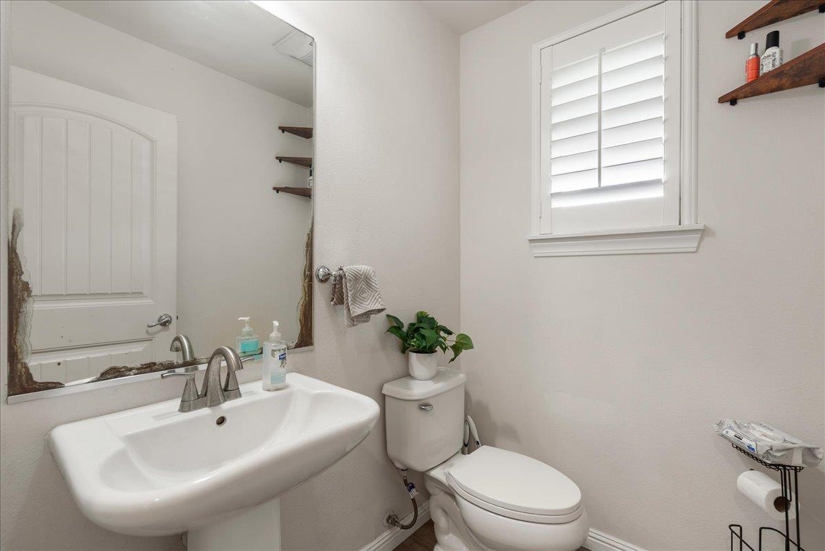 214 Alake Street Kahului, HI 96732 - Photo 19 of 27 a bathroom with a sink mirror and toilet