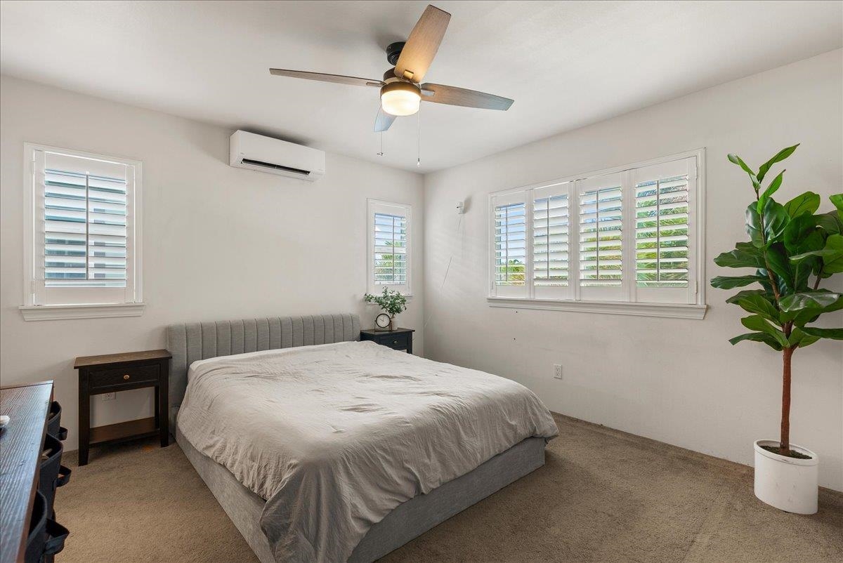 214 Alake Street Kahului, HI 96732 - Photo 20 of 27 a bedroom with a bed and a potted plant