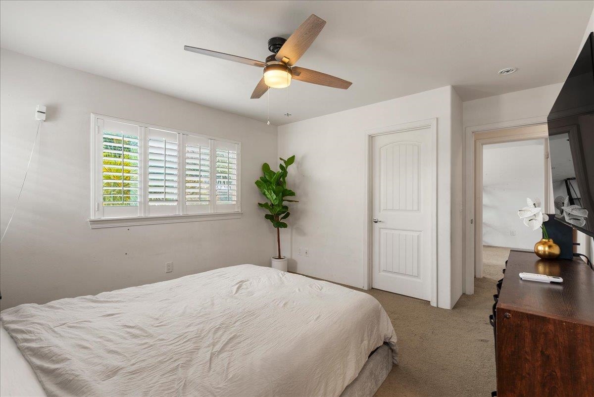 214 Alake Street Kahului, HI 96732 - Photo 21 of 27 a bedroom with a bed and a chandelier