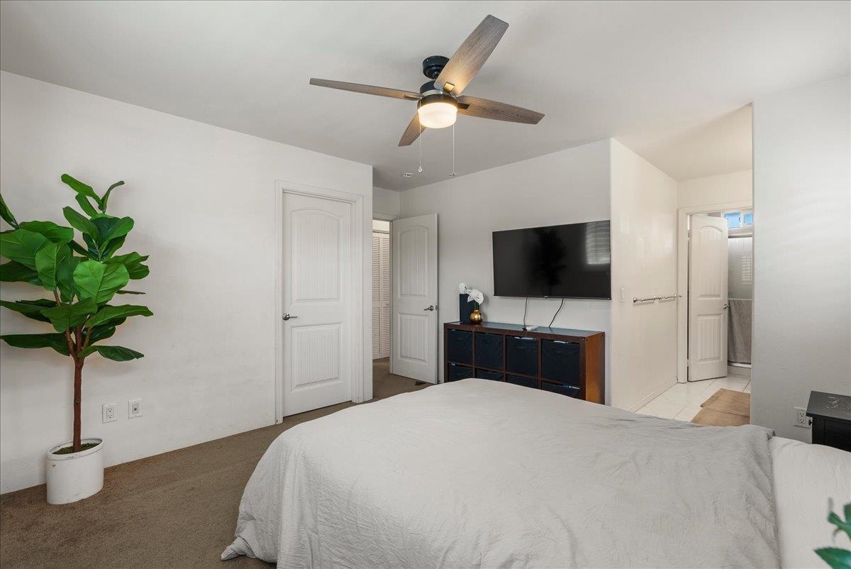 214 Alake Street Kahului, HI 96732 - Photo 26 of 27 a bedroom with a bed and a flat screen tv
