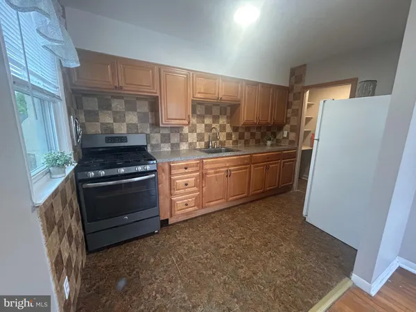 a kitchen with granite countertop a refrigerator and a stove