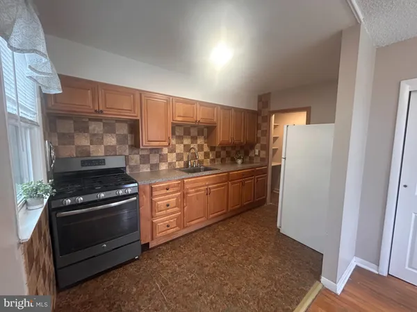 a kitchen with a stove and a refrigerator