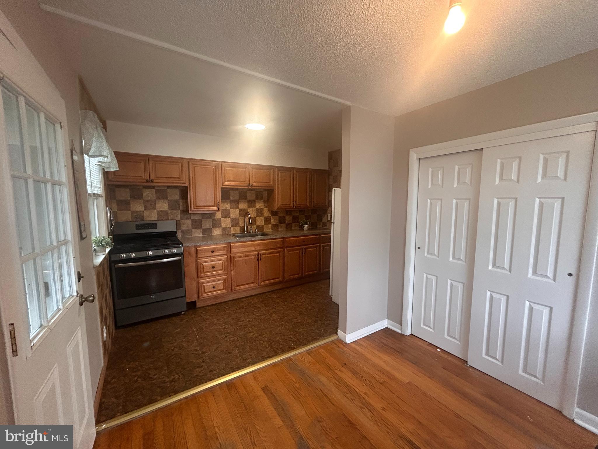 300 Evesham Avenue West Magnolia, NJ 08049 - Photo 14 of 25 a kitchen with a stove and a refrigerator