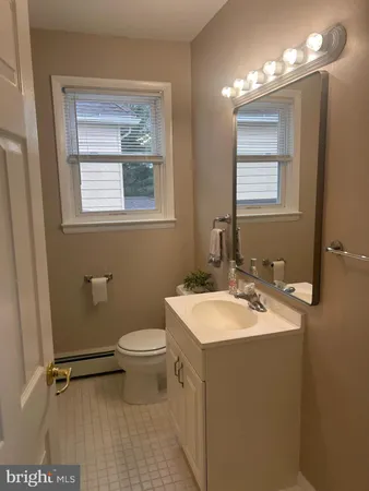 a bathroom with a sink toilet and mirror