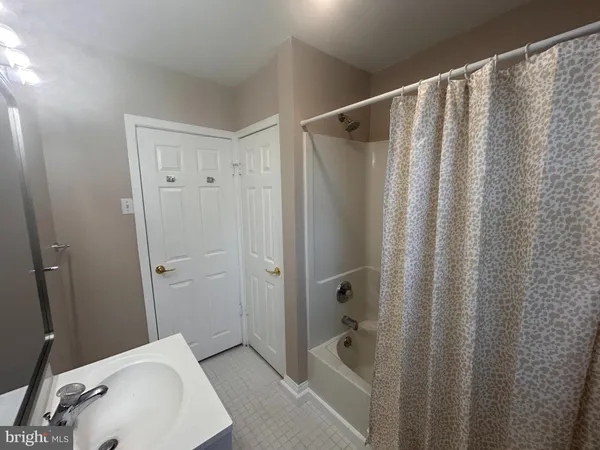 a bathroom with a sink and shower
