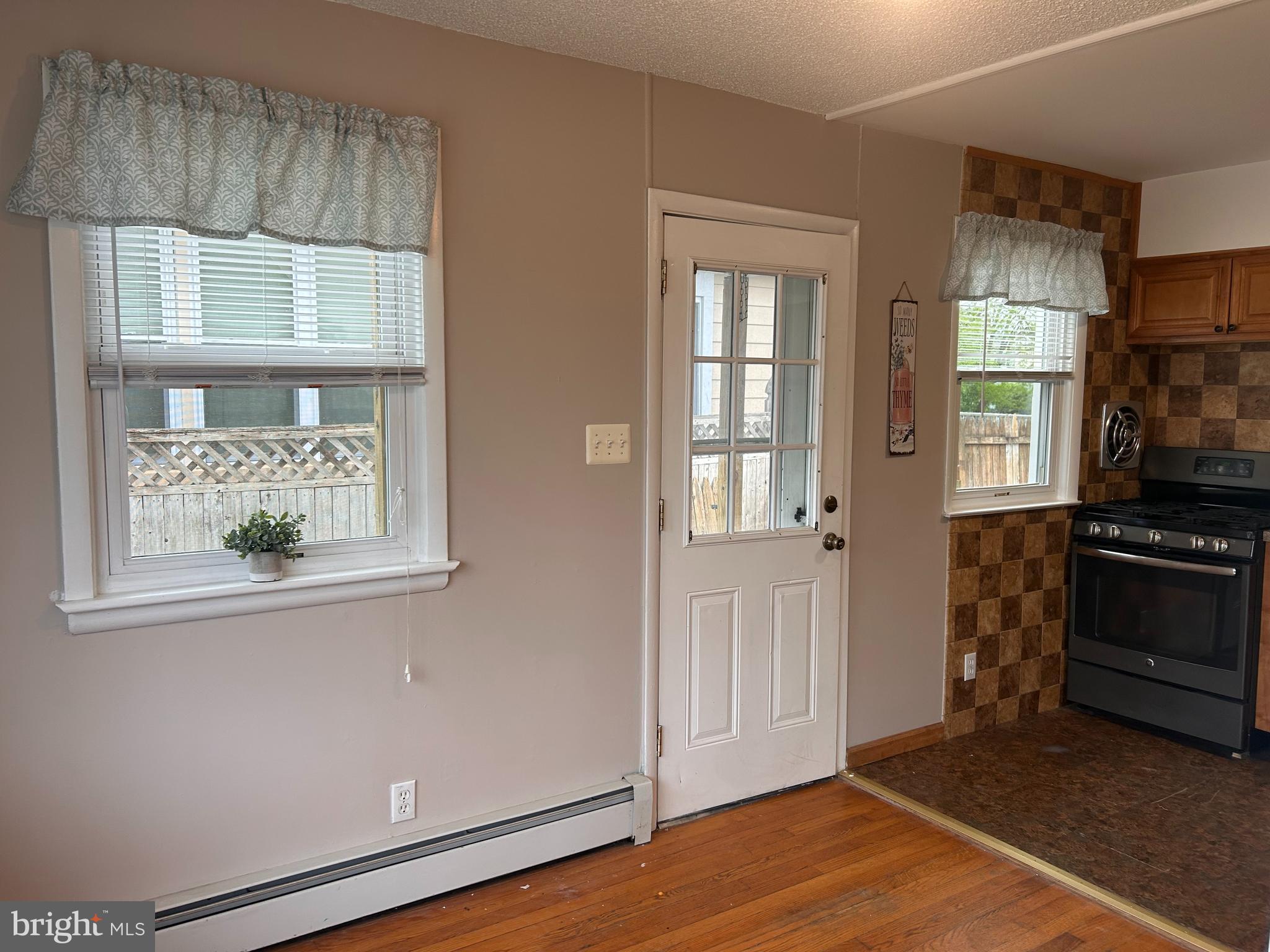 300 Evesham Avenue West Magnolia, NJ 08049 - Photo 9 of 25 an empty room with wooden floor cabinet and windows