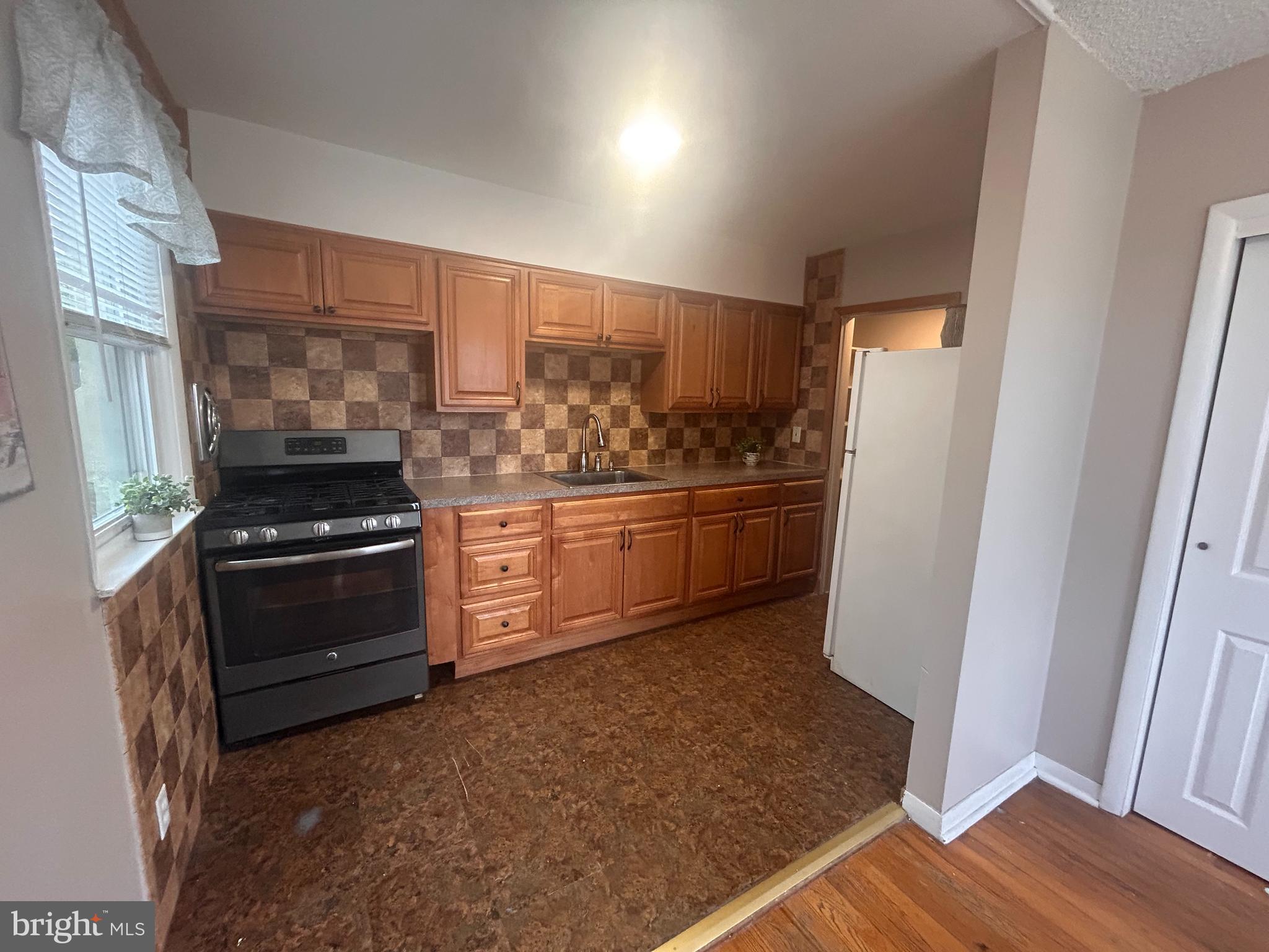300 Evesham Avenue West Magnolia, NJ 08049 - Photo 10 of 25 a kitchen with a stove and a refrigerator