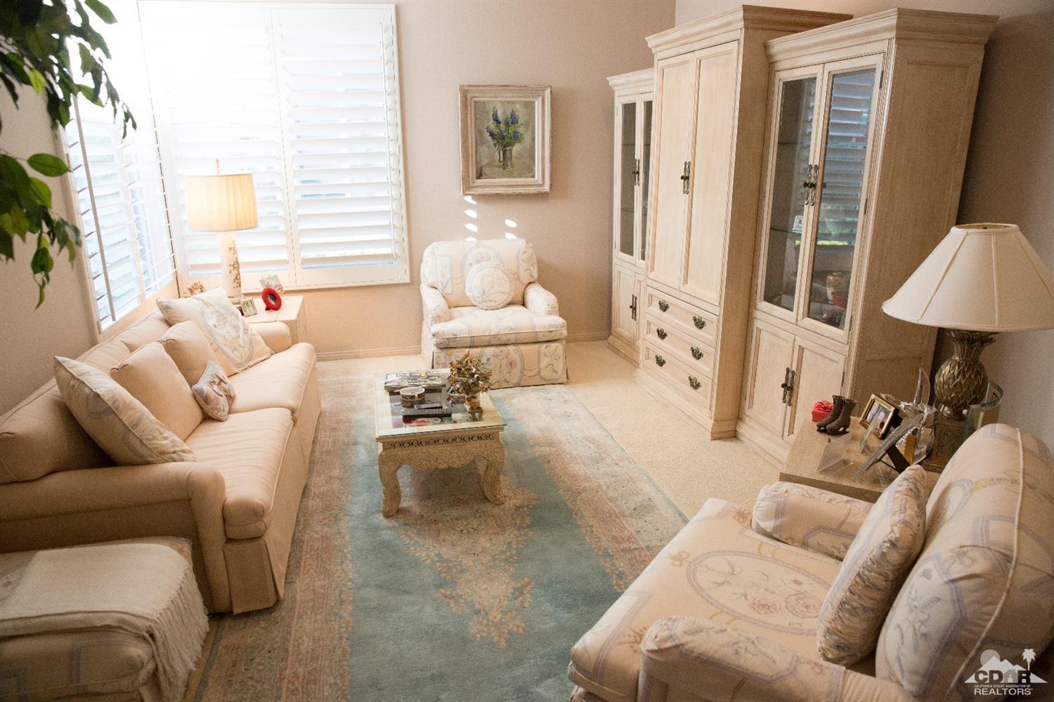 7 Sherwood Road Rancho Mirage, CA 92270 - Photo 20 of 35 a living room with furniture and a lamp