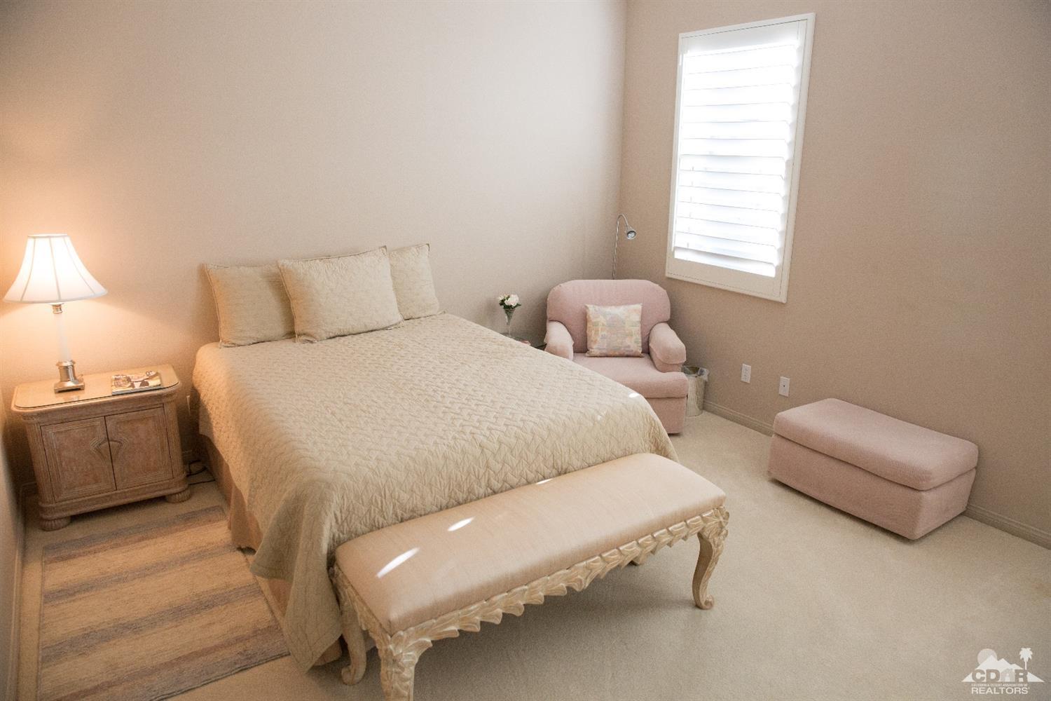7 Sherwood Road Rancho Mirage, CA 92270 - Photo 10 of 35 a bedroom with a bed and a couch