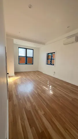 a view of kitchen with kitchen island a sink wooden floor and black appliances