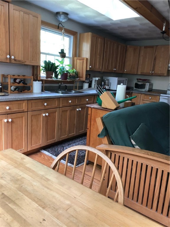 347 Westcott Road Scituate, RI 02857 - Photo 5 of 12 Kitchen with yellow pine floor open to dining area and fire placed conversation spot
