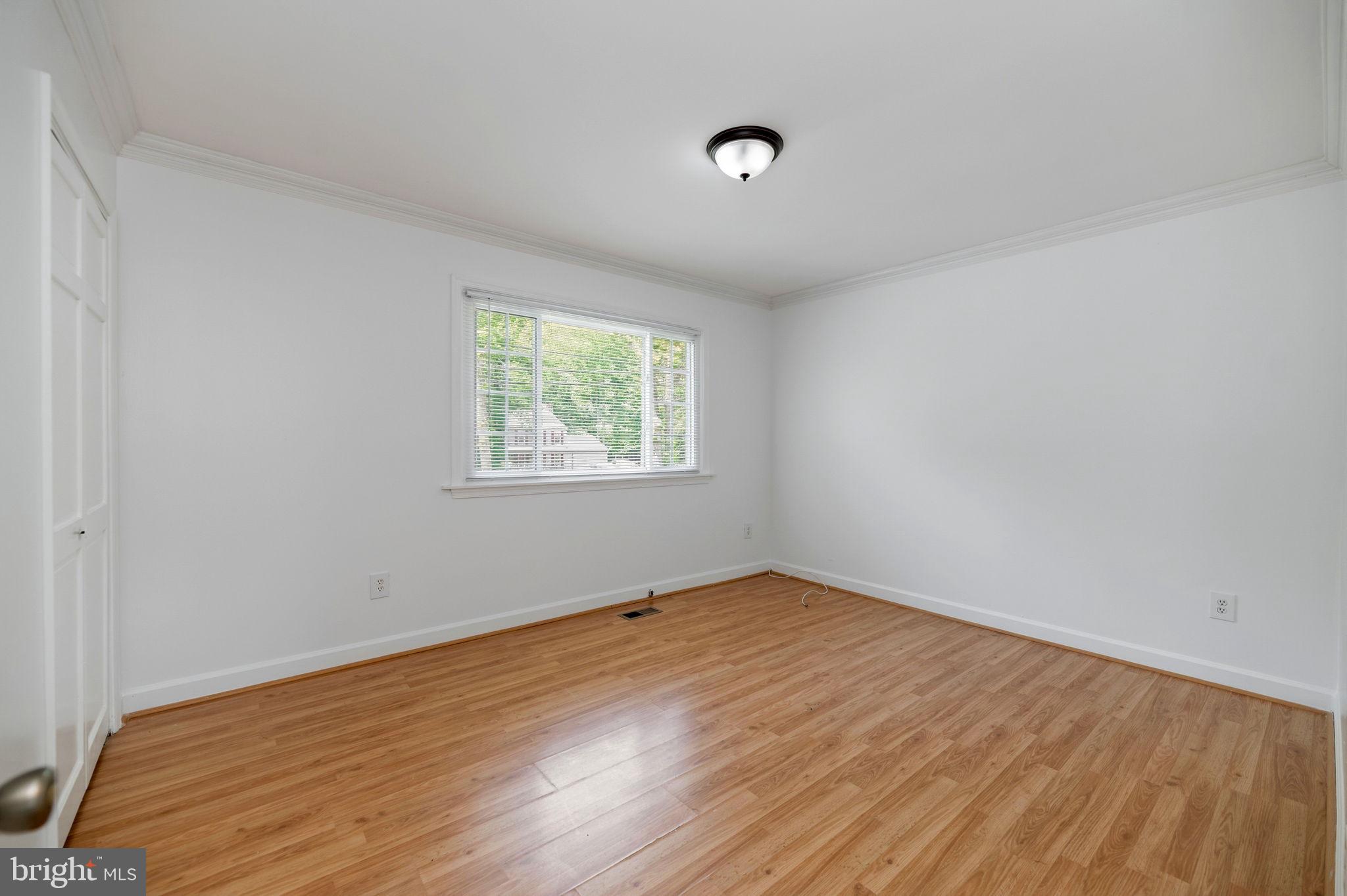 11325 Bacon Race Road Woodbridge, VA 22192 - Photo 17 of 54 an empty room with wooden floor and windows