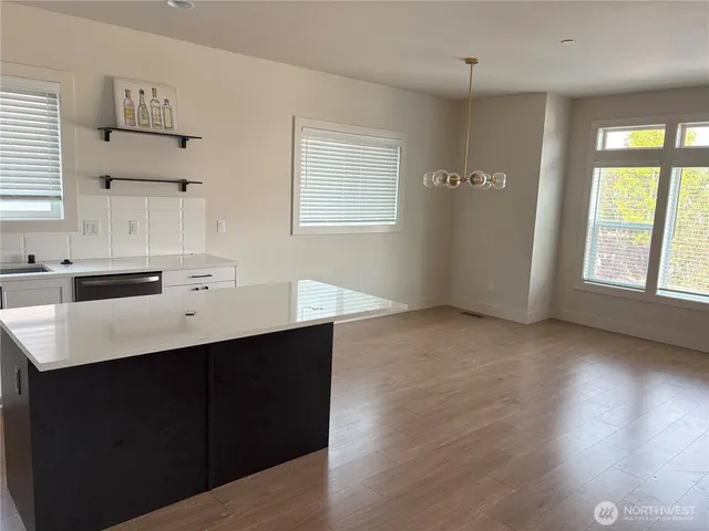 a kitchen with a sink cabinets and wooden floor
